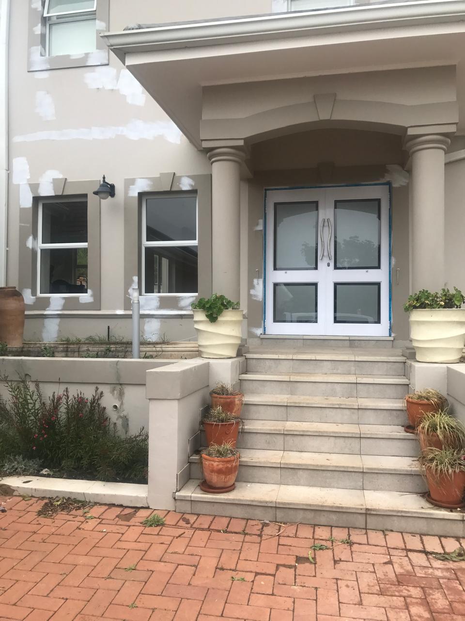 Top hung aluminium windows installed in a residential building in KZN, showcasing durable aluminium window frames.
