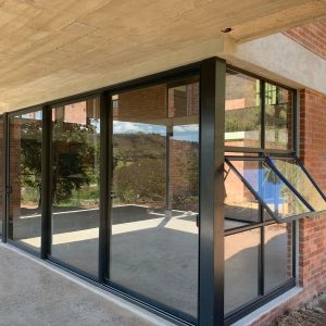 Top hung casement aluminium windows with black frames installed in modern residential building in KZN.